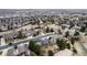 An aerial view showcasing neighborhood homes with mature trees and landscaping, under a cloudy sky at 15846 W Bayaud Dr, Golden, CO 80401