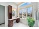 Bathroom vanity featuring a marble countertop, wood cabinets, and a large window at 15846 W Bayaud Dr, Golden, CO 80401