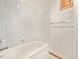 Tiled bathroom with white tiled bathtub and chrome fixtures at 15846 W Bayaud Dr, Golden, CO 80401