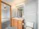 Bathroom with a wood vanity, toilet, and walk-in shower, combining essential features with functional design at 15846 W Bayaud Dr, Golden, CO 80401