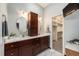 Bathroom with double vanity, marble countertop, and a walk-in closet, providing ample storage and a touch of luxury at 15846 W Bayaud Dr, Golden, CO 80401