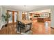 Warm dining room with hardwood floors, an adjacent kitchen, and natural light at 15846 W Bayaud Dr, Golden, CO 80401