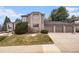 Beautiful two-story home with a three-car garage and a well-manicured lawn on a sunny day at 15846 W Bayaud Dr, Golden, CO 80401