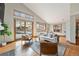 Cozy living room featuring hardwood floors, a sliding door to a deck, and bright windows at 15846 W Bayaud Dr, Golden, CO 80401