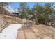 Stone patio featuring a table, chairs, and stone landscaping at 15846 W Bayaud Dr, Golden, CO 80401