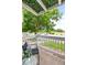 Private balcony with outdoor seating overlooking parking and greenery at 13404 E Jewell Ave # 101, Aurora, CO 80012