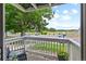 Private balcony with outdoor seating overlooking parking and greenery at 13404 E Jewell Ave # 101, Aurora, CO 80012