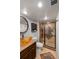 Modern bathroom featuring glass bowl sink, framed mirror, and elegant tile surround in the shower at 13404 E Jewell Ave # 101, Aurora, CO 80012