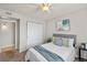Bedroom with natural light features a bed, side table and spacious closet at 13404 E Jewell Ave # 101, Aurora, CO 80012