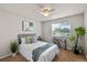 Bright bedroom features a ceiling fan, large window, and comfortable furnishings at 13404 E Jewell Ave # 101, Aurora, CO 80012