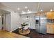 Dining area featuring stainless steel fridge, modern lighting and tile floors at 13404 E Jewell Ave # 101, Aurora, CO 80012