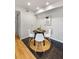 Cozy dining area features a round table, stylish chairs, and modern decor on stylish brown flooring next to light wood flooring at 13404 E Jewell Ave # 101, Aurora, CO 80012