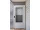 White front door to home with storm door and exterior cladding at 13404 E Jewell Ave # 101, Aurora, CO 80012