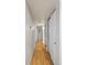 Long hallway featuring smooth wooden floors and neutral colored walls at 13404 E Jewell Ave # 101, Aurora, CO 80012
