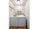 Efficient laundry area with washer, dryer, wire shelving, and decor creating a clean and organized space at 13404 E Jewell Ave # 101, Aurora, CO 80012