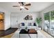 Bright living room with stylish decor, hardwood floors, and balcony access at 13404 E Jewell Ave # 101, Aurora, CO 80012