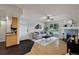 Well-lit living room open to kitchen, features hardwood floors, fireplace and balcony at 13404 E Jewell Ave # 101, Aurora, CO 80012