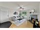Cozy living room with hardwood floors, fireplace, and balcony access at 13404 E Jewell Ave # 101, Aurora, CO 80012