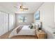 Inviting bedroom featuring neutral walls, ceiling fan, plush bedding, and plenty of natural light at 13404 E Jewell Ave # 101, Aurora, CO 80012