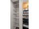 Walk-in pantry with ample shelving space next to stainless steel microwave and stove at 13404 E Jewell Ave # 101, Aurora, CO 80012
