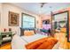 Bright bedroom with wood floors, flamingo wallpaper and a stylish rug at 1365 N Corona St # 11, Denver, CO 80218