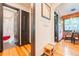 This hallway is painted white with a warm hardwood floor and has black trim around each door and opening at 1365 N Corona St # 11, Denver, CO 80218