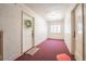 Inviting hallway leading to unit #11 with neutral walls, carpet, and a decorative wreath on the door at 1365 N Corona St # 11, Denver, CO 80218