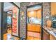 View through doorways to dining room and kitchen with stainless steel dishwasher and wood cabinets at 1365 N Corona St # 11, Denver, CO 80218