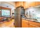 Bright kitchen with wooden cabinets, stainless steel fridge and a sunny dining nook at 1365 N Corona St # 11, Denver, CO 80218