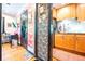 View through doorways to flamingo wallpaper and kitchen with wood cabinets at 1365 N Corona St # 11, Denver, CO 80218