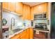 Bright kitchen features wooden cabinets, granite counters and stainless steel appliances at 1365 N Corona St # 11, Denver, CO 80218