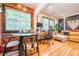 Charming living room and dining area with hardwood floors, exposed brick, and abundant natural light at 1365 N Corona St # 11, Denver, CO 80218