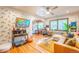 Cozy living room with Zebra wallpaper, hardwood floors, a ceiling fan, and abundant natural light at 1365 N Corona St # 11, Denver, CO 80218