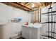 Unfinished basement laundry room with washer, dryer, and ample storage at 8716 Starwood Ln, Parker, CO 80134