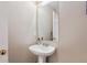 Simple bathroom with pedestal sink and mirror at 8716 Starwood Ln, Parker, CO 80134