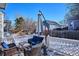 Back deck with patio furniture and umbrella at 8716 Starwood Ln, Parker, CO 80134