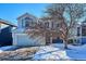 Two-story house with attached garage and landscaping; snowy yard at 8716 Starwood Ln, Parker, CO 80134