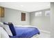 Cozy bedroom with plush blue bedding, neutral carpeting and natural light at 365 Seminole Dr, Boulder, CO 80303
