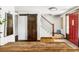Bright entryway with wooden floors, stylish barn door, staircase and red front door at 365 Seminole Dr, Boulder, CO 80303