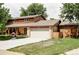 Charming two-story home with a large front yard, an attached two-car garage and cedar shake siding at 365 Seminole Dr, Boulder, CO 80303
