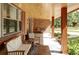 Inviting front porch with comfortable seating, wood ceiling and supporting posts with nice brick accents at 365 Seminole Dr, Boulder, CO 80303