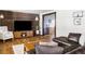 Bright living room featuring a wood accent wall, hardwood floors, and comfortable leather sofa at 365 Seminole Dr, Boulder, CO 80303