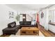 Bright living room with hardwood floors, stylish decor, comfortable leather sofa, and a staircase at 365 Seminole Dr, Boulder, CO 80303