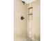 Tiled shower with a built in shower caddy and sleek bronze hardware at 365 Seminole Dr, Boulder, CO 80303