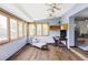 Bright sunroom with wood floors, abundant windows, and relaxing lounge chair at 365 Seminole Dr, Boulder, CO 80303