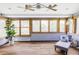 Bright sunroom with wood floors, abundant windows, and cozy seating at 365 Seminole Dr, Boulder, CO 80303