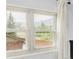 Window with view of the Rocky Mountains and mature trees at 365 Seminole Dr, Boulder, CO 80303