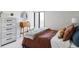 Bright bedroom features stylish furniture, a modern ceiling fan, and a window view at 460 S Marion Pkwy # 1701, Denver, CO 80209