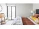 A bedroom with white brick accent wall and sliding glass door to balcony at 460 S Marion Pkwy # 1701, Denver, CO 80209