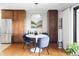 Bright dining area featuring hardwood floors, modern lighting, and an adjacent kitchen with stainless steel appliances at 460 S Marion Pkwy # 1701, Denver, CO 80209